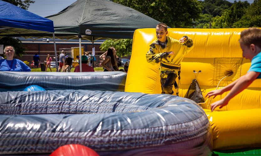 A boy plays on an inflatable game field